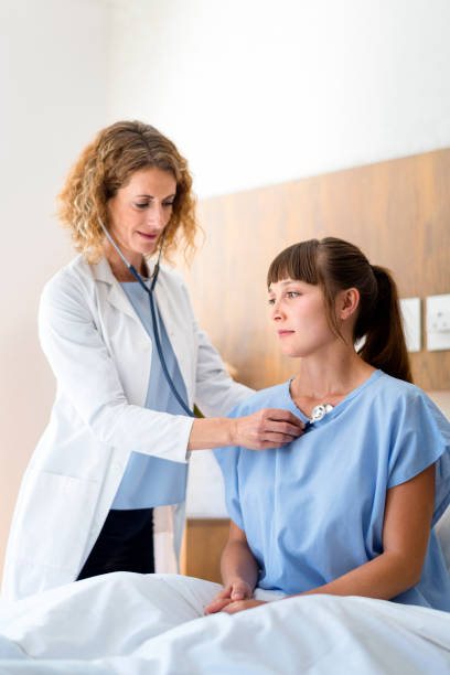istock Female doctor examining patient with stethoscope 1065769668