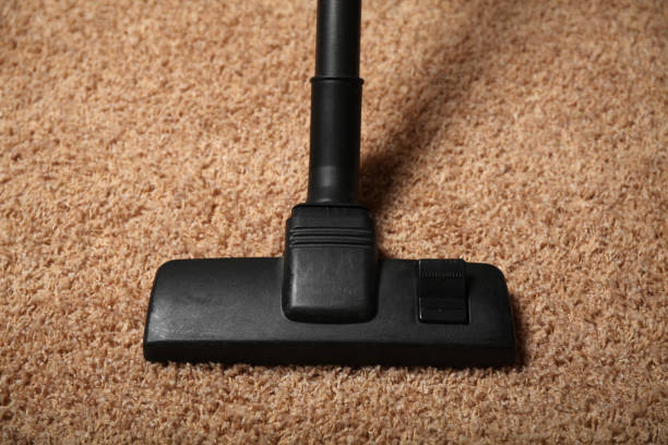 istock Black vacuum cleaner on dirty carpet. Housework 1065769990