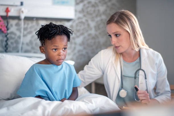 istock Pediatrician consoling sick boy at hospital ward 1065770374