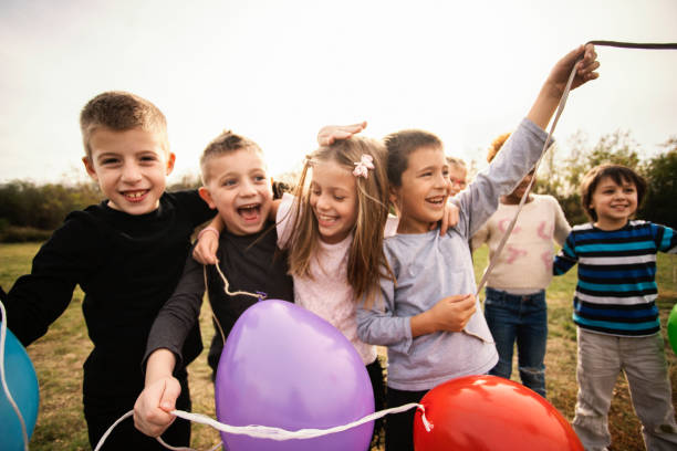 istock Cheerful kids playing with balloon's 1065770398