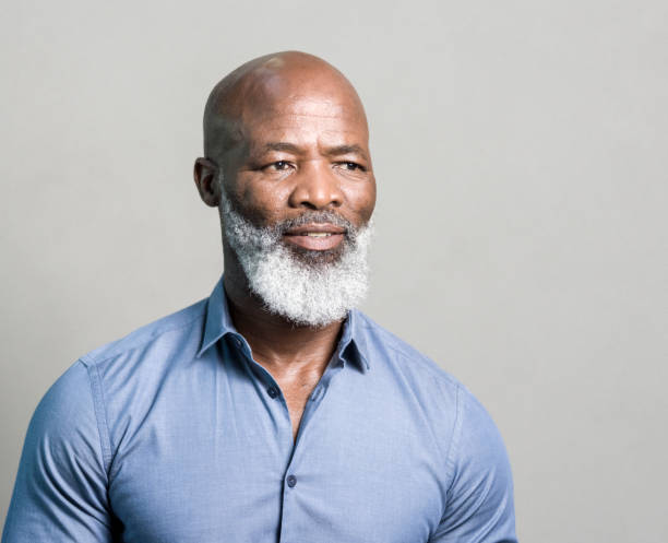 Thoughtful African-American against gray background.