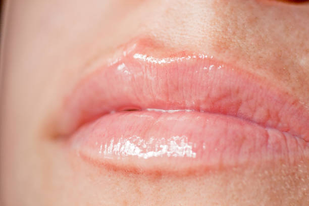 istock shiny and sexy woman lips 1065772248