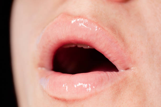 istock shiny and sexy woman lips 1065772254