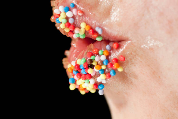 istock woman lips covered in colorful sugar balls 1065772322