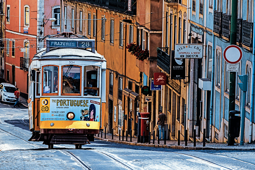 Lisbon, Portugal - August 03, 2018: The number 28 Lisbon tram, considered one of the main attractions of the city, passes through the popular tourist districts of Graca, Alfama, Baixa and Estrela.