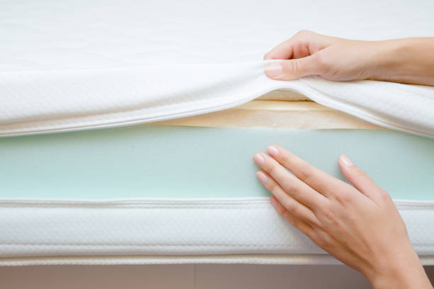 Woman's hands touching different layers of new mattress. Checking hardness and softness. Choice of the best type and quality. Front view. Close up. Woman's hands touching different layers of new mattress. Checking hardness and softness. Choice of the best type and quality. Front view. Close up. latex stock pictures, royalty-free photos & images