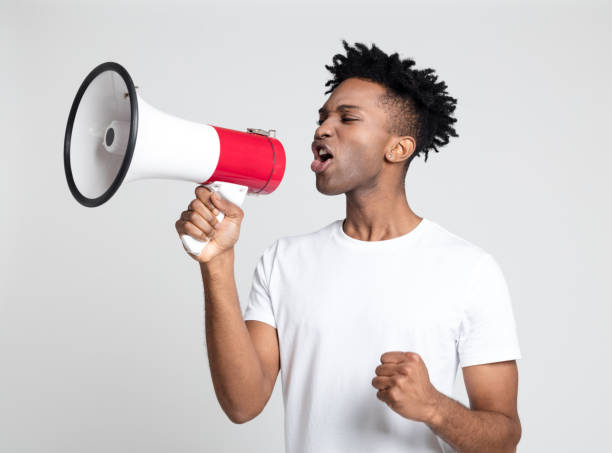 istock Young guy making an announcement with megaphone 1065774950