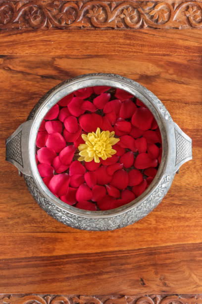Indian Rose Petal Arrangement in silver bowl on table