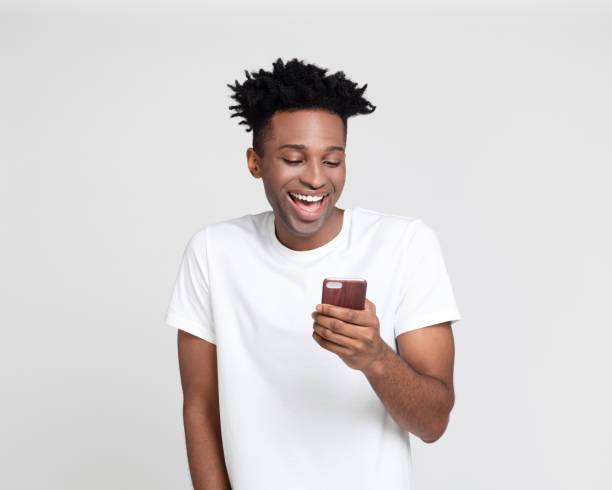 istock Cheerful afro american man using phone 1065775220