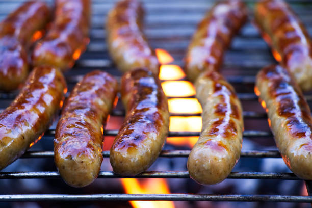 istock Grilling sausages on barbecue grill. 1065775252