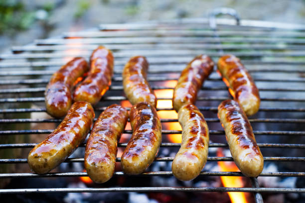 istock Grilling sausages on barbecue grill. 1065775294