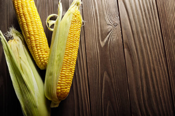 istock Ripe fresh organic sweet corncobs on wooden table 1065775678