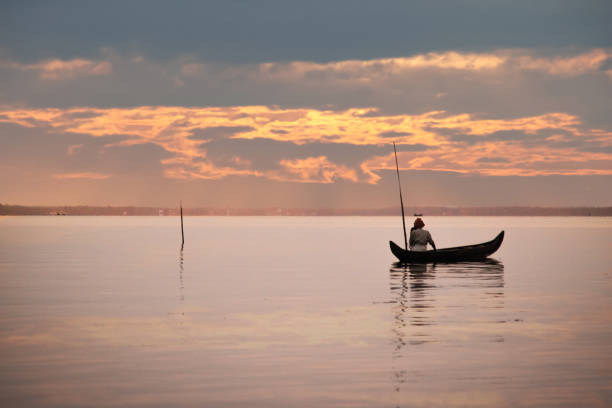 istock Kerala Fisherman watching sunset 1065777224