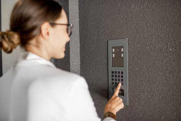 Woman entering code on the building entrance