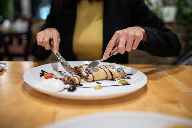istock Woman cutting crepes 1065782270