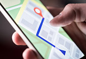 Map application in smartphone. Man navigating in city with mobile phone. Person using cellphone and searching hotel with navigation app.