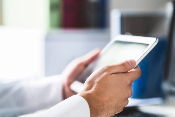 istock Doctor and medical professional using tablet at work in health care. Physician using digital electronic mobile device. Patient database online on the internet. 1065782706
