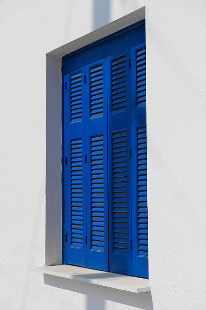 istock Greek home with windows closed by blue wooden shutters 106578646