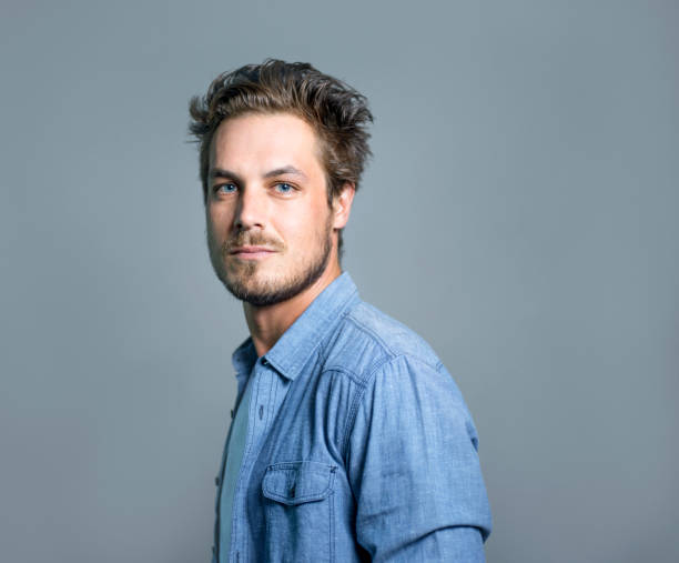 istock Portrait of confident man against gray wall 1065787916