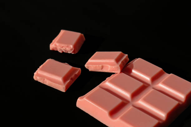 istock Pink chocolate bar and pieces isolated on black background. 1065789102