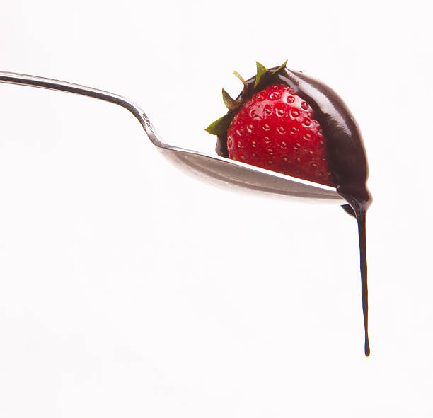 istock Chocolate Sauce drips off StrawBerry Fruit on Silver Spoon 106578992