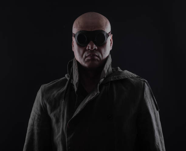 istock bald man with glasses on a black background 1065790344