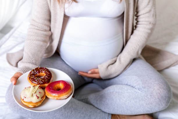 istock Pregnancy and unhealthy eating concept 1065793396