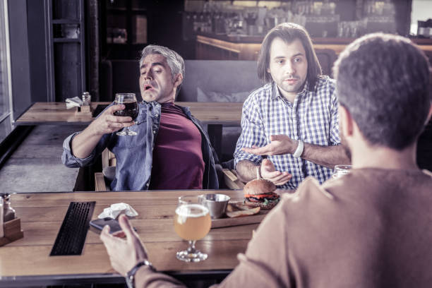 istock Frustrated male person staring at bocal with beer 1065794968