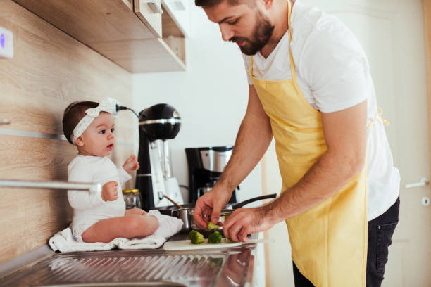 istock Father and daughter helping in the kitchen 1065795056
