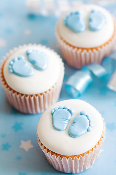 istock Little cupcakes for a baby shower with blue footprints 106579522