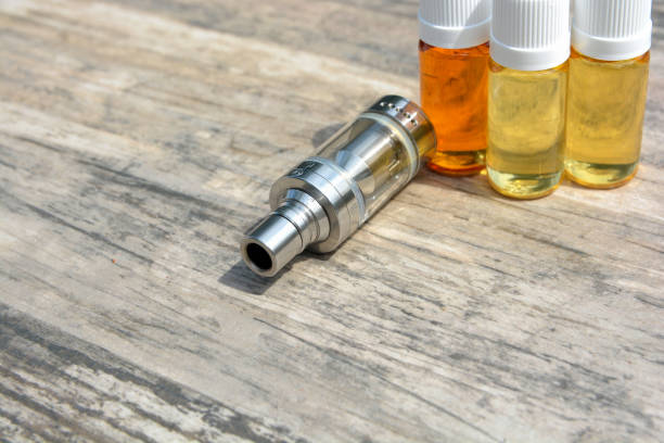 istock E - cigarette for vaping , technical devices.The liquid in the bottle 1065797660