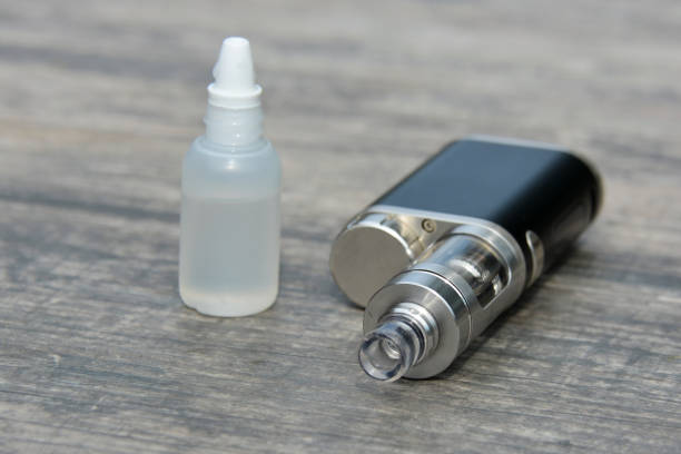 istock E - cigarette for vaping , technical devices.The liquid in the bottle 1065797806