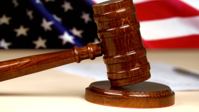 Judge gavel hammer against the US flag, american legal system, justice, law