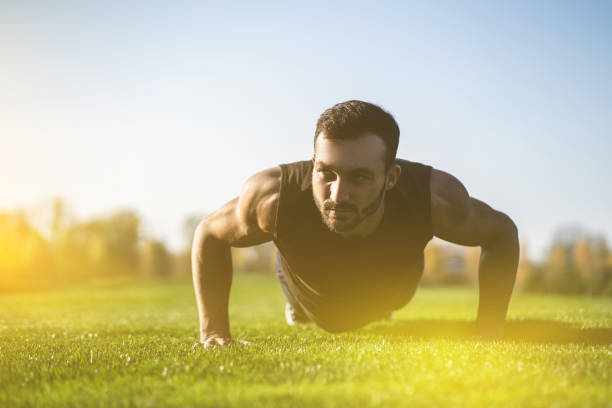 istock The handsome man pushing up on the grass 1065801532