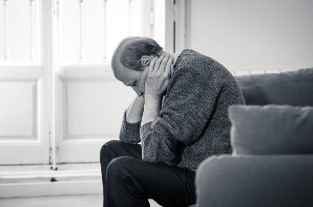 istock Senior old man feeling desperate sad looking worried depressed thoughtful and lonely on couch at home in Aging Mental health Personal problems and Life style concept. 1065803612