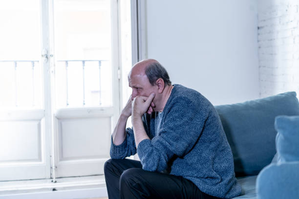 istock Overwhelmed old senior man suffering alone at home feeling confused sad alone on couch at home in Aging Retirement widower Dementia and Alzheimer concept. 1065803710