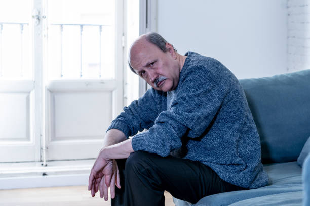 istock Senior old man feeling desperate sad looking worried depressed thoughtful and lonely on couch at home in Aging Mental health Personal problems and Life style concept. 1065803712
