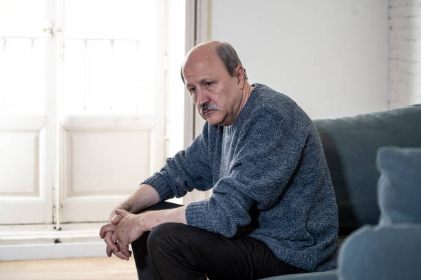 istock Overwhelmed old senior man suffering alone at home feeling confused sad alone on couch at home in Aging Retirement widower Dementia and Alzheimer concept. 1065803784