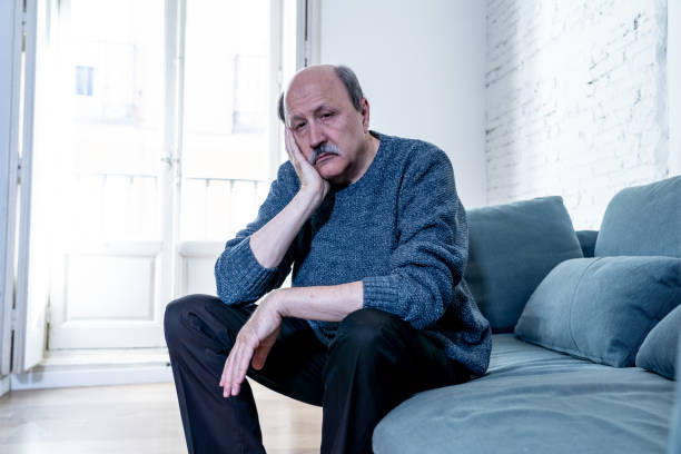 istock Senior old man feeling desperate sad looking worried depressed thoughtful and lonely on couch at home in Aging Mental health Personal problems and Life style concept. 1065803842
