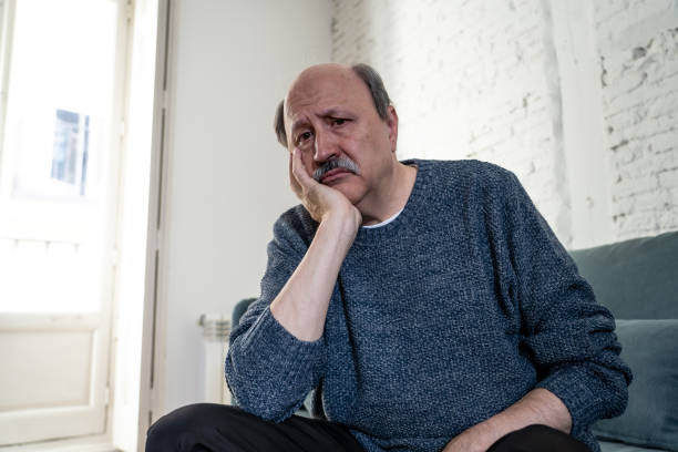 istock Senior old man feeling desperate sad looking worried depressed thoughtful and lonely on couch at home in Aging Mental health Personal problems and Life style concept. 1065803846