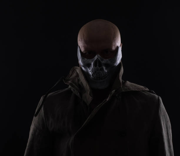 evil man in a scary mask on a black background