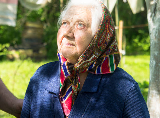old woman with a scarf and white hair typical granny in eastern europe rural areas