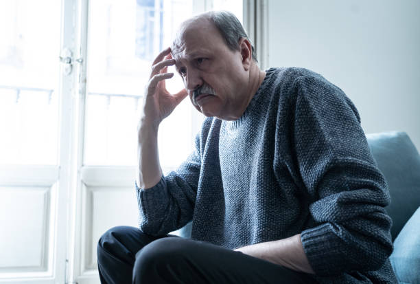 istock Overwhelmed old senior man suffering alone at home feeling confused sad alone on couch at home in Aging Retirement widower Dementia and Alzheimer concept. 1065804224
