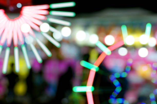 istock Defocused and blurred image of people at amusement park 1065806618