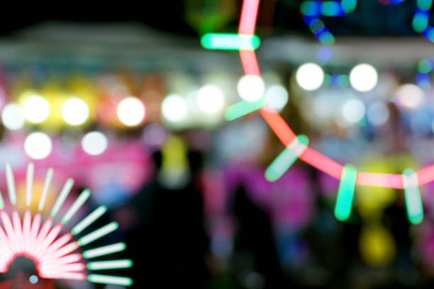istock Defocused and blurred image of people at amusement park 1065806764