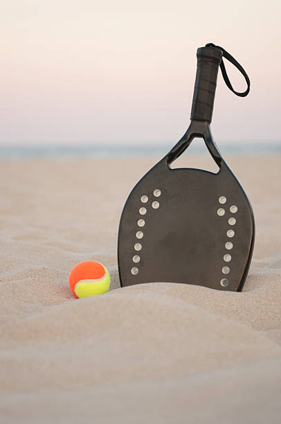 istock beach tennis racket and ball on the sunset 106580849
