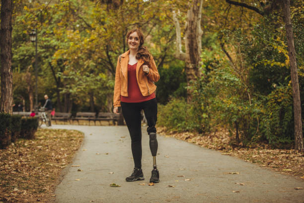 Woman with amputee leg standing in the park