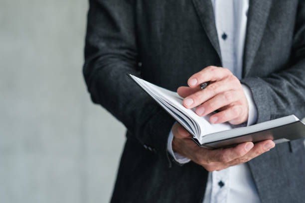 istock man hold notepad agenda schedule business affair 1065810852