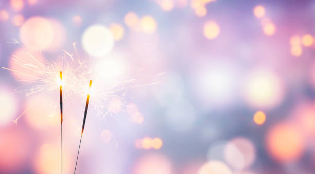 two sparklers on abstract pastel background