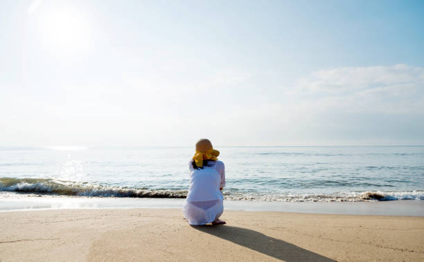 istock Sad woman crouching on the beach 1065817518